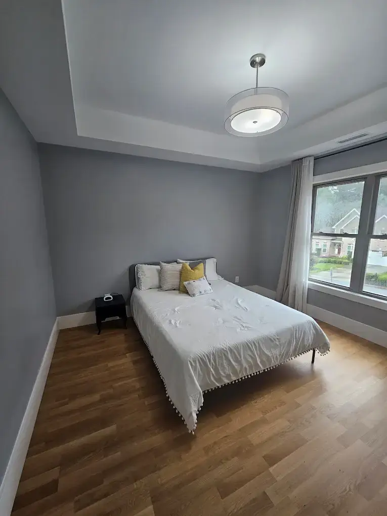 Freshly cleaned bedroom with neatly made bed