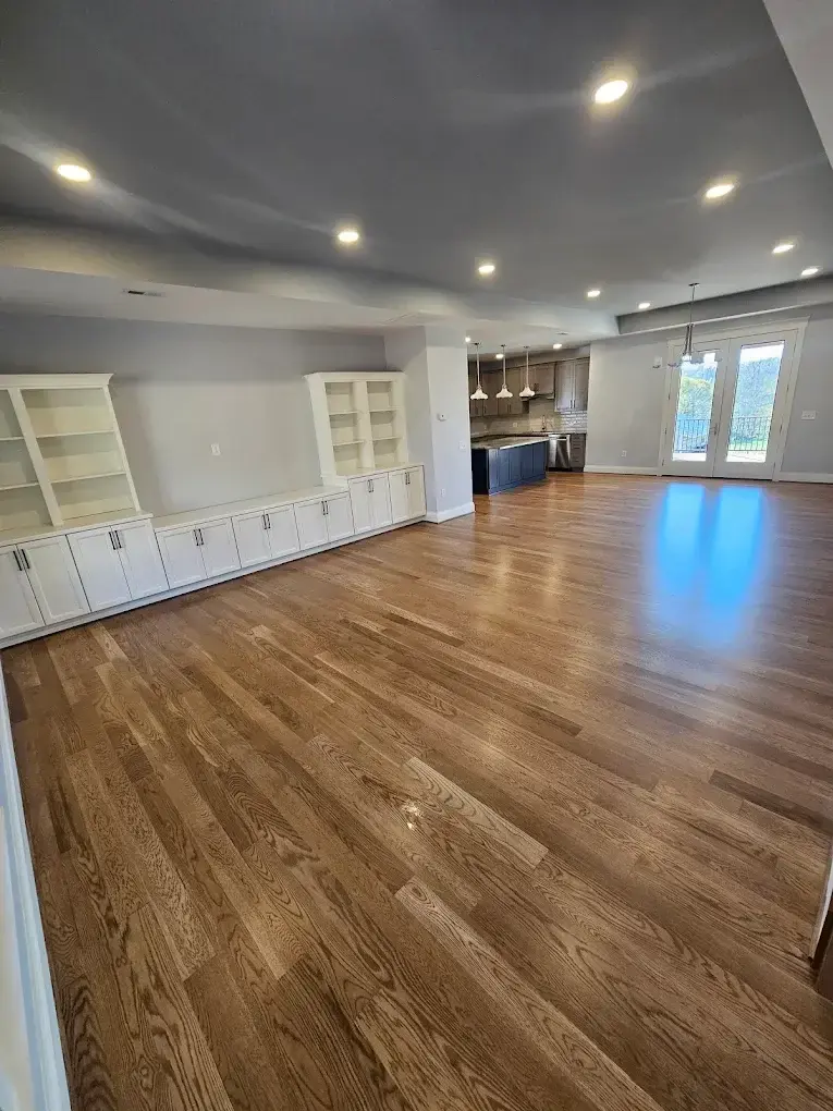 Gleaming hardwood floors in an empty room after floor cleaning